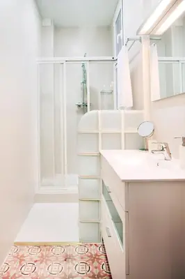 a white bathroom with a shower and a sink at Casa Valeta in Barcelona
