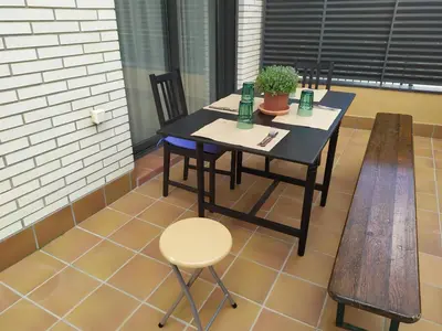 a table with two chairs and a plant on it at Apartamento Arenys de Munt - Costa Barcelona, Maresme - in Arenys de Munt