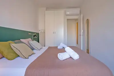 a bedroom with two white towels on a bed at Habitat Apartments Plaza España Urban in Barcelona