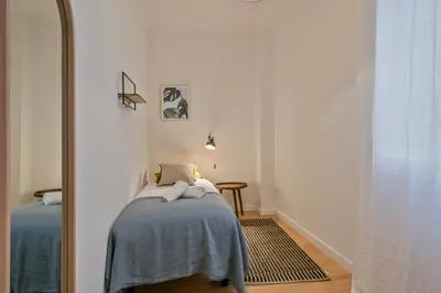 a bedroom with a mirror and a bed in a room at Habitat Apartments Plaza España Urban in Barcelona