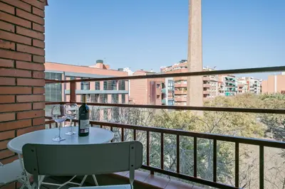 a balcony with a table and a bottle of wine at Habitat Apartments Plaza España Urban in Barcelona