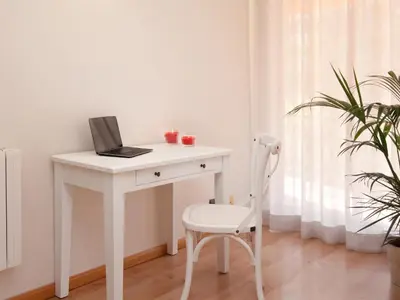 a white desk with a laptop and a chair at Click&Flat Luxury mistral in Barcelona