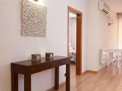 a room with a wooden table and a picture on the wall at Click&Flat Luxury mistral in Barcelona