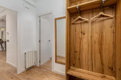 a room with a wooden door and a mirror at Poble Sec 3BR 2BA Balcony Sleeps 7 in Barcelona