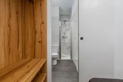 a bathroom with a toilet and a shower at Poble Sec 3BR 2BA Balcony Sleeps 7 in Barcelona