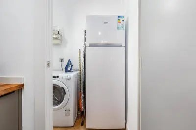 a white bathroom with a toilet and a shower at Poble Sec 3BR 2BA Balcony Sleeps 7 in Barcelona