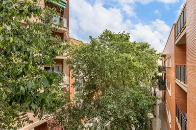 a refrigerator in a kitchen with a washing machine at Poble Sec 3BR 2BA Balcony Sleeps 7 in Barcelona