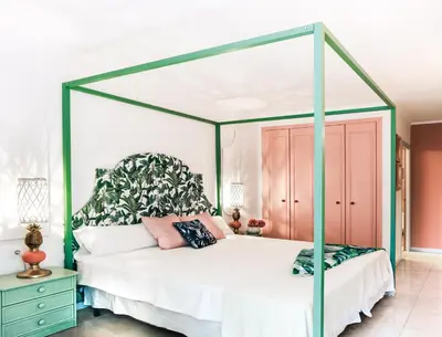 a bedroom with a white bed with a canopy at 1840 Apartments Sitges by Suma Hotels in Sitges