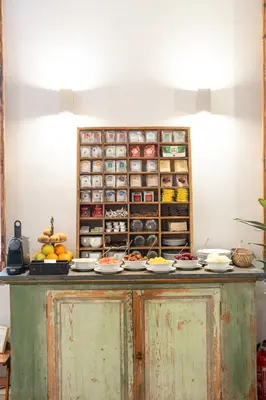 a table with plates of food on top at We Boutique Hotel Barcelona in Barcelona