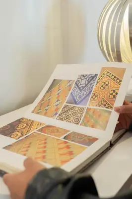 a person is holding a book with pictures on it at We Boutique Hotel Barcelona in Barcelona