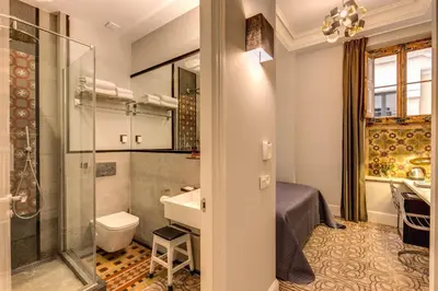 a bathroom with a shower and a sink and a toilet at We Boutique Hotel Barcelona in Barcelona