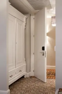 a hallway with a white cabinet and a door at We Boutique Hotel Barcelona in Barcelona