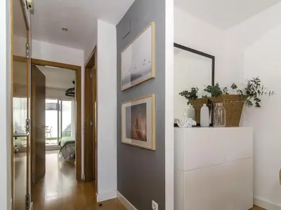 a hallway with a wall with two pictures on it at Sitges Spaces Terrace Apartment- 1 Bedroom, 1Bathroom, Huge Terrace in Sitges