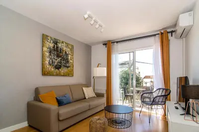 a living room with a couch and a table at Sitges Spaces Terrace Apartment- 1 Bedroom, 1Bathroom, Huge Terrace in Sitges