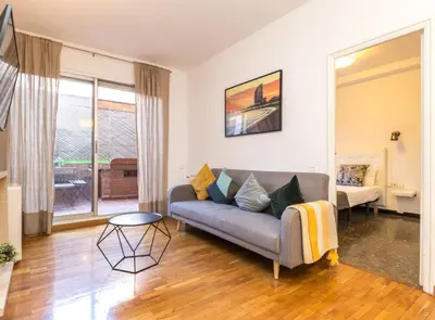 a living room with a couch and a table at Find Calm at this cozy City Sanctuary with terrace in Barcelona