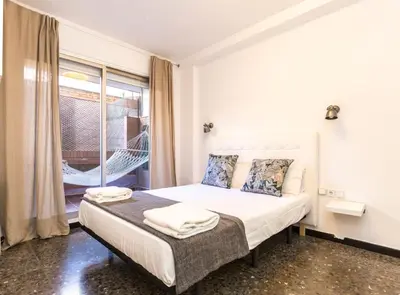 a bedroom with a bed and a large window at Find Calm at this cozy City Sanctuary with terrace in Barcelona