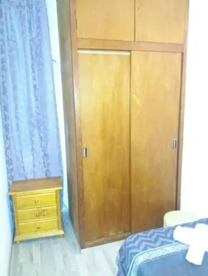 a bedroom with a wooden door and a wooden dresser at Apartamento Sagrada Familia in Barcelona