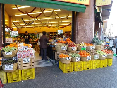 a market with fruits and vegetables on display in a store at Apartamento Sagrada Familia in Barcelona