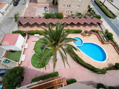 an overhead view of a resort with a swimming pool and a palm tree at Apartment Sun and Beach by Interhome in Cunit