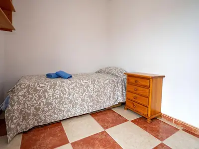 a bedroom with a bed and a wooden dresser at Apartment Sun and Beach by Interhome in Cunit