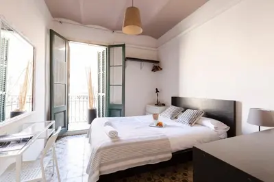 a bedroom with a large white bed and a desk at 1814 - AB Sagrada Família Cartagena in Barcelona
