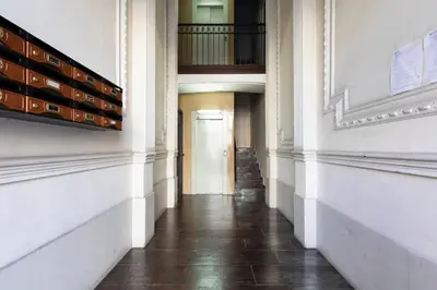 an empty hallway of a building with a door at 1814 - AB Sagrada Família Cartagena in Barcelona