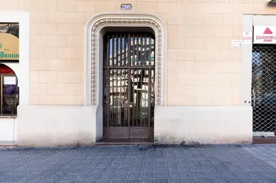 a door with a wrought iron gate on a building at 1814 - AB Sagrada Família Cartagena in Barcelona