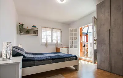 a small bedroom with a bed and a window at 5 Bedroom Awesome Home In Alella in Alella