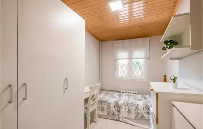 a small kitchen with a table and a window at 5 Bedroom Awesome Home In Alella in Alella