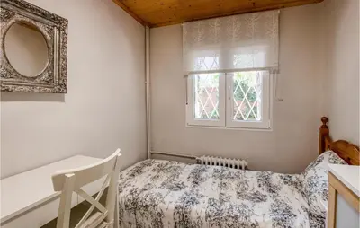 a bedroom with a bed and a window at 5 Bedroom Awesome Home In Alella in Alella