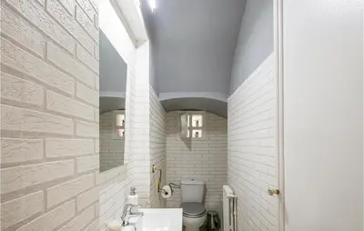 a bathroom with a toilet and a sink at 5 Bedroom Awesome Home In Alella in Alella