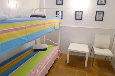 a hospital room with a bed and a chair at Fragata Beach Seaview in Sitges
