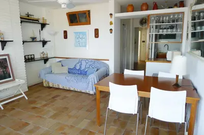 a living room with a table and a couch at Fragata Beach Seaview in Sitges