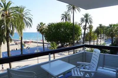a balcony with chairs and a view of the beach at Fragata Beach Seaview in Sitges