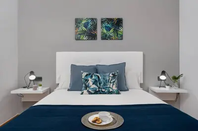a bedroom with a bed with a plate of food on it at Lodging Apartments Villa de Gracia 2 bedroom cozy apartment in Barcelona