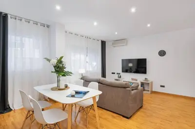 a living room with a table and a couch at Lodging Apartments Villa de Gracia 2 bedroom cozy apartment in Barcelona