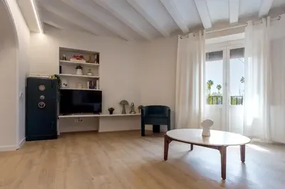 a living room with a tv and a coffee table at Mirador 1840 in Barcelona