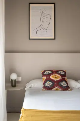 a bedroom with a bed with a picture on the wall at Mirador 1840 in Barcelona