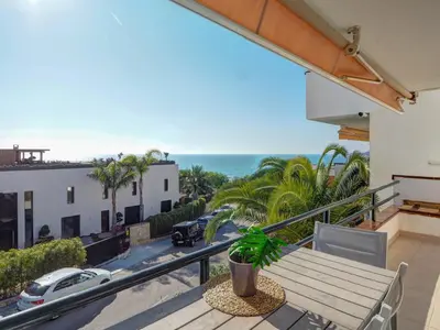 a balcony with a table and a view of the ocean at Balmins White by Hello Homes Sitges in Sitges