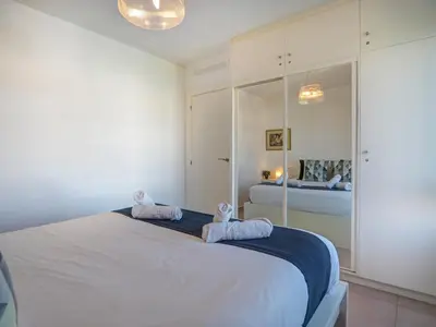 a bedroom with a bed with two towels on it at Balmins White by Hello Homes Sitges in Sitges