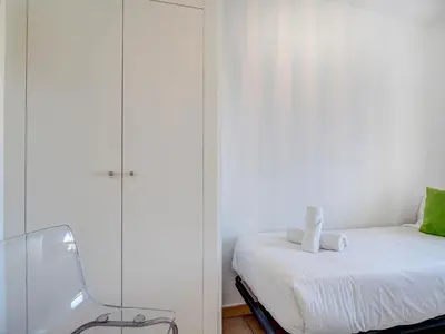 a bedroom with a bed and a glass wall at Balmins White by Hello Homes Sitges in Sitges