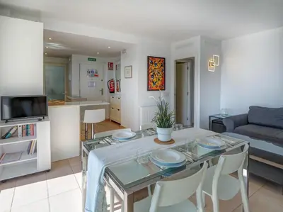 a living room with a table and a couch at Balmins White by Hello Homes Sitges in Sitges