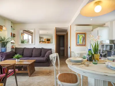 a living room with a couch and a table at Los Condes Penthouse by Hello Homes Sitges in Sitges