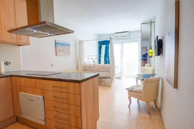 a kitchen with a counter and a dining room at The Loft by Hello Homes Sitges in Sitges