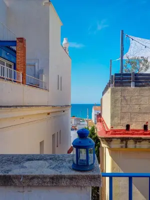 a blue jar sitting on a ledge next to some buildings at Barco Attic by Hello Homes Sitges in Sitges