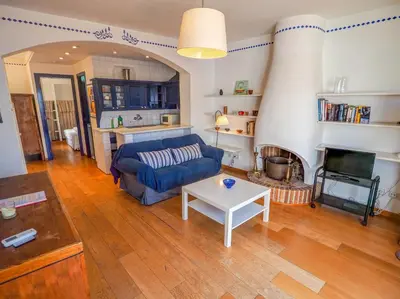 a living room with a blue couch and a table at Barco Attic by Hello Homes Sitges in Sitges