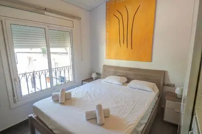 a bedroom with a bed with two crosses on it at Harbour terraces by Hello Homes Sitges in Sitges