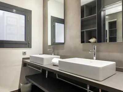 a bathroom with two sinks and a mirror at Click&Flat Luxury cabanyes in Barcelona