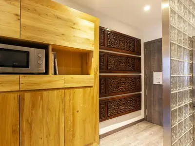 a living room with a microwave and wooden cabinets at Click&Flat Luxury cabanyes in Barcelona