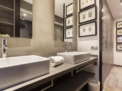 a bathroom with two sinks and a large mirror at Click&Flat Luxury cabanyes in Barcelona